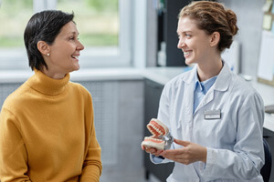 woman discussing treatment options with dentist