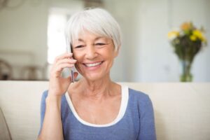 Smiling older woman talking on phone